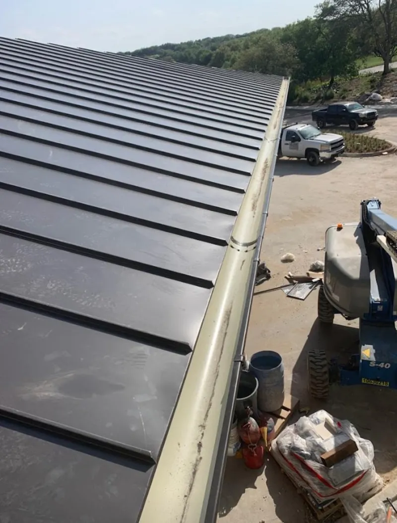 Standing seam panel and gutter detail on a metal roofing jobsite in Holmdel